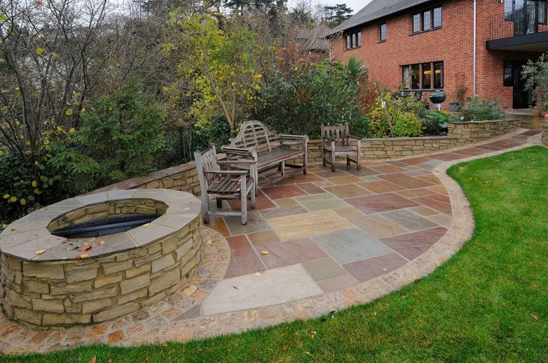 Sandstone patio with sunken firepit and seating area