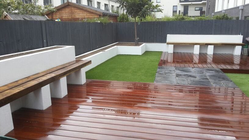 Landscaped garden — dark patio, decking and rendered seating walls
