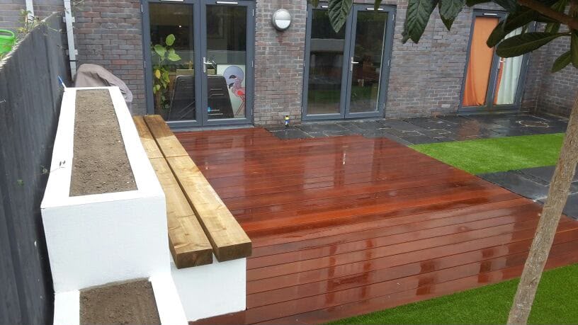 Enclosed garden with artificial grass and slatted fencing