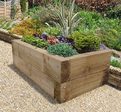 Oak sleeper raised bed installed to a landscaped garden