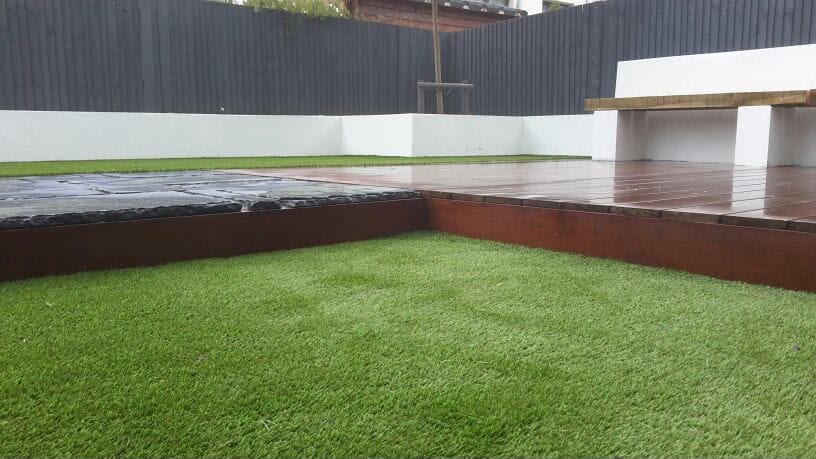 Hardwood decking against slatted timber screening