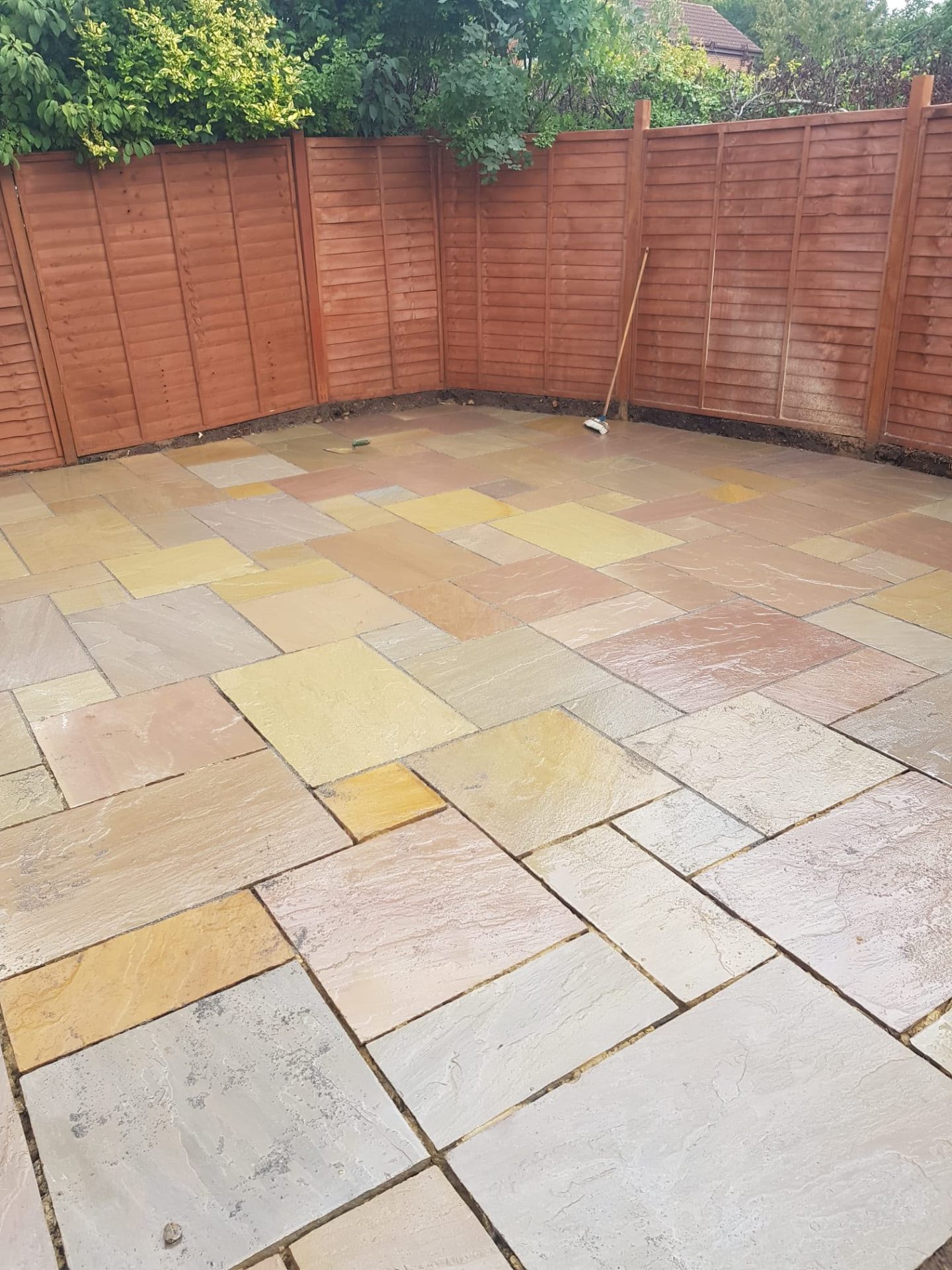 Multi-tone sandstone patio behind a bungalow
