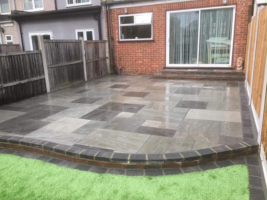 Dark stone patio with contrasting decorative border
