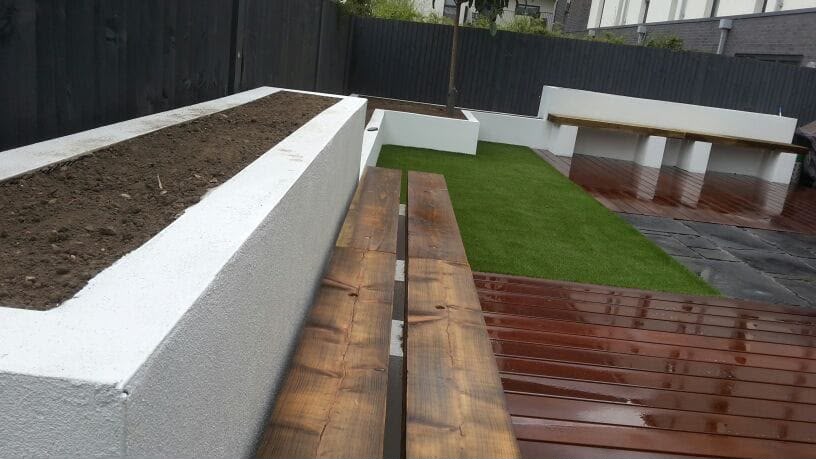 White rendered raised bed with hardwood decking edge